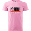 A pink T-shirt featuring the bold "Positive Energy" design in striking text.