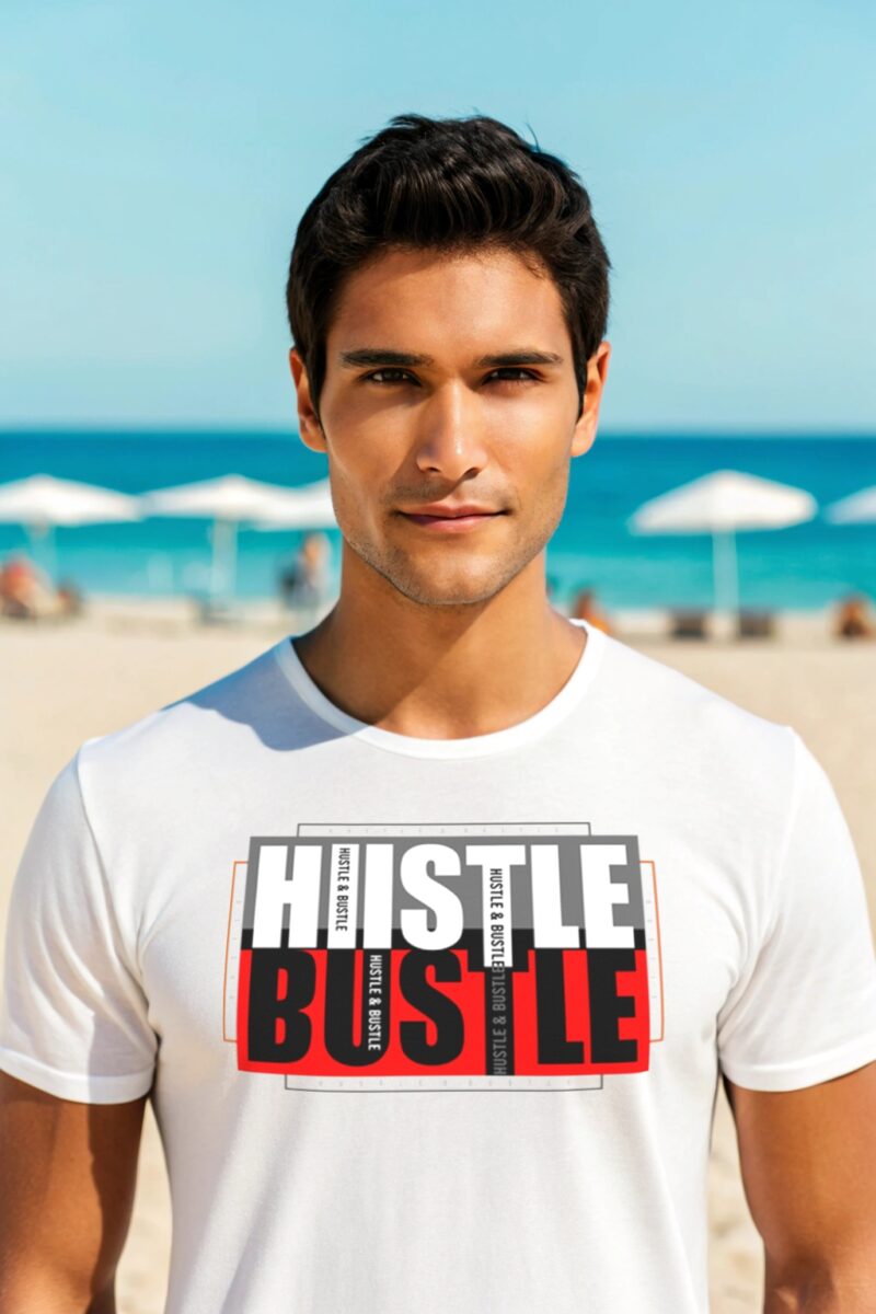 Young man in a white T-shirt with bold “Hustle & Bustle” typography design, standing on a sunny beach.