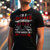 Man wearing a black T-shirt with the slogan “I’m a Trucker – I Don’t Stop When I’m Tired, I Stop When I’m Done” and two truck graphics, standing on a city street at night.