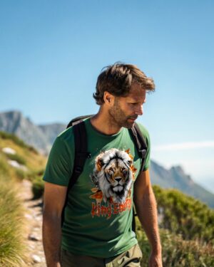 Man hiking in a green T-shirt with a white lion and autumn leaves print, featuring the text “King Energy.”