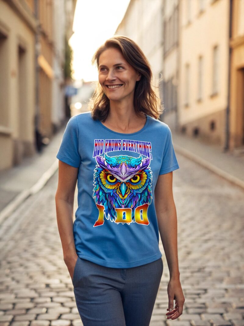 A woman wearing a blue T-shirt with a bright, colorful owl print and the text "Hoo Knows Everything?" above the owl and emoji "100" below it.