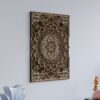 Angled view of portrait multilayer wooden mandala wall art displayed on a light wall in a modern interior