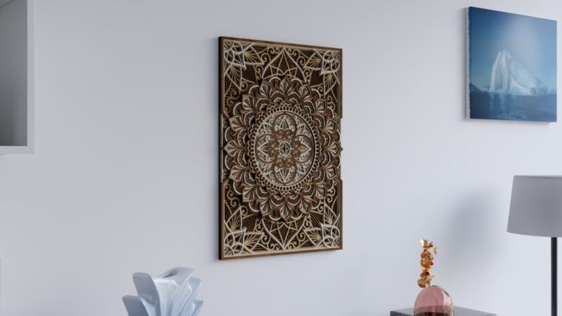 Angled view of portrait multilayer wooden mandala wall art displayed on a light wall in a modern interior