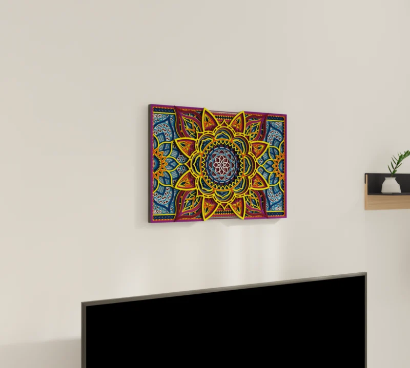 Multilayer Wooden Mandala wall art with a bright symmetrical floral geometric design in yellow, blue, red, and purple, shown on a light wall above a TV from an angled view.