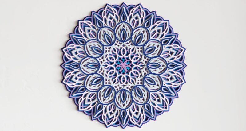 Front view of a Multilayer Wooden Mandala in blue, white, and pink with a symmetrical layered design