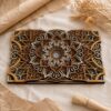 Multilayer wooden mandala wall art in warm brown, golden, cream, and white tones, shown close up on neutral fabric with dried flowers, kraft paper, and a small brush.