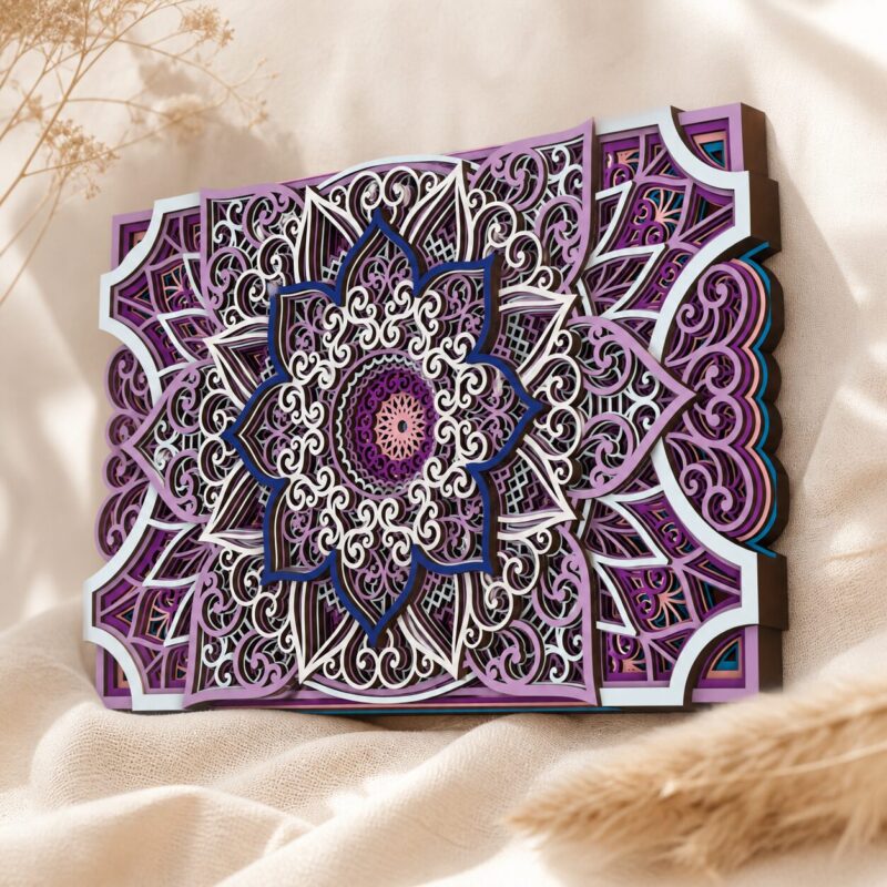 Multilayer wooden mandala wall art with purple, white, dark blue, and turquoise accents, featuring ornate floral lacework and layered geometric details on a soft beige fabric background.