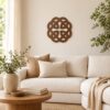 Walnut Fourfold Celtic Knot wall decor displayed above a cream sofa in a bright living room.