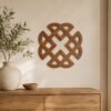 Large Walnut Celtic Knot wall decor displayed above a wooden cabinet in a minimalist neutral interior.