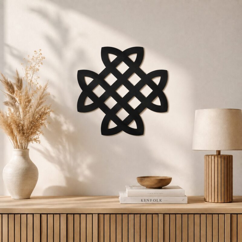 Black Celtic Knot wall decor displayed above a wooden cabinet in a warm minimalist interior.