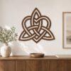 Large walnut Celtic Knot wall decor displayed above a wooden cabinet in a warm modern interior.