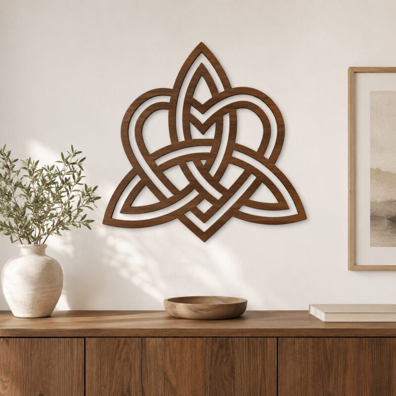 Large walnut Celtic Knot wall decor displayed above a wooden cabinet in a warm modern interior.