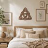 Walnut Celtic Knot wall decor displayed above a bed in a warm neutral bedroom with natural wood furniture.