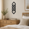 Black Celtic knot wall decor displayed above a wooden dresser in a neutral bedroom