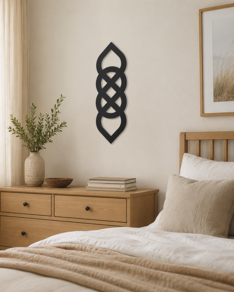 Black Celtic knot wall decor displayed above a wooden dresser in a neutral bedroom
