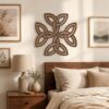 Walnut Celtic Knot wall decor displayed above a bed in a warm bedroom with natural wood furniture and neutral textiles.